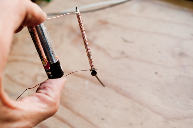 Wrap the wire around the nail, connect the the battery, and you get a magnet